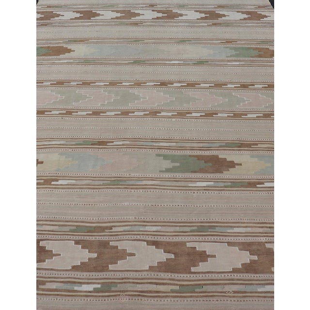 Measures: 7'6 x 11'3 Elevate your living space with this exquisite vintage Turkish Kilim rug, featuring a harmonious blend...