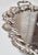 Lovely, silver plated tray from France, crafted circa 1940. This elegant serving tray sits on four detailed feet and...