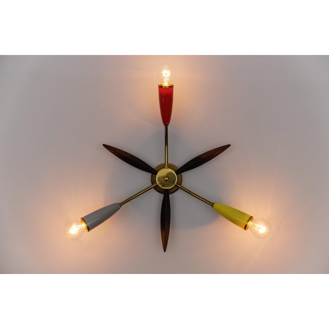 Midcentury 5-armed brass Sputnik lamp in the manner of Arteluce. 1950s. Executed in lacquered metal, brass and glass. The...