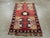 This Mid-20th century Turkish Oushak rug, measuring 1' 7" x 2' 9", is a striking example of the bold, geometric artistry...