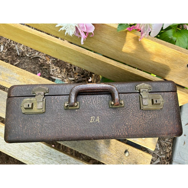 Wonderful early 20th-century cowhide suitcase with brass clasps in good condition. The exterior shows sign of use but is...