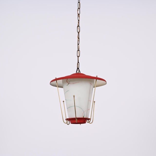 Amazing midcentury round opaline glass and brass red lantern chandelier. This fantastic piece was designed in Italy during...