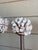 Vintage elegant pair of classical pillar stands, featuring a sophisticated antiqued silver and gold finish with a...