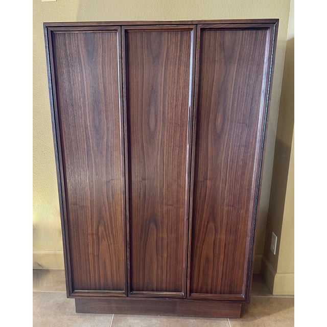 A statement piece providing fantastic storage! This Mid Century Walnut Gentleman's Cabinet is in excellent condition....