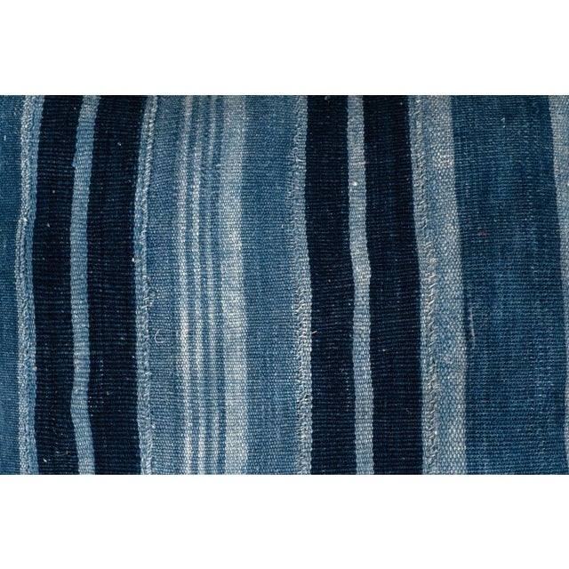 Long rich faded indigo stripe lumbar cushion made from vintage handwoven and hand-dyed slubby cotton fabric. This...