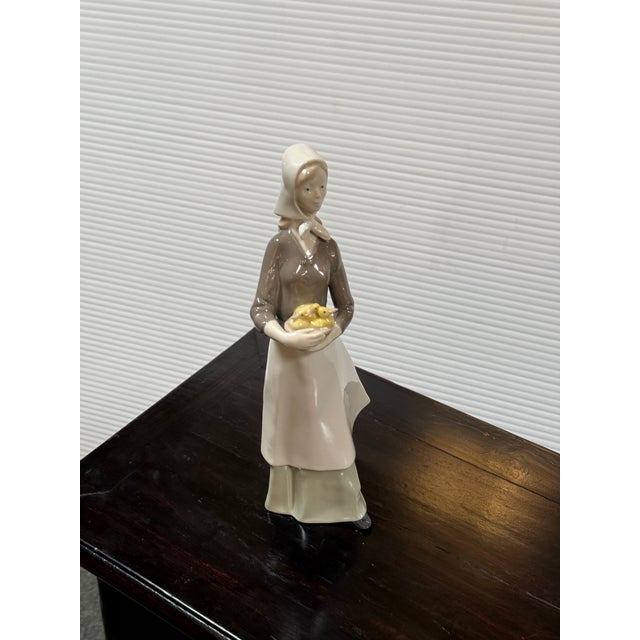 Design Plus Gallery presents a Porcelain Figurine of a Girl Carrying Ducklines from the Carl Scheidig Factory (1906–1972)...