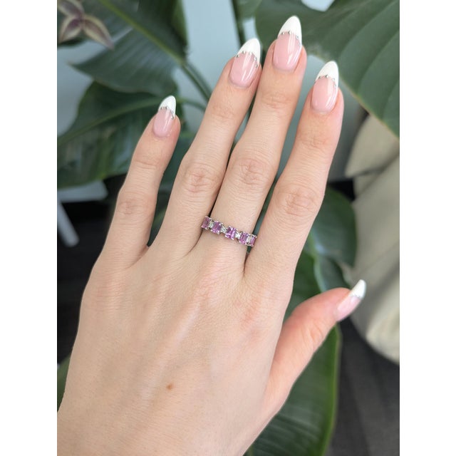 Five pink sapphires run across this solid 14K white gold band, set with four earth-mined diamond accents. Sapphire's...