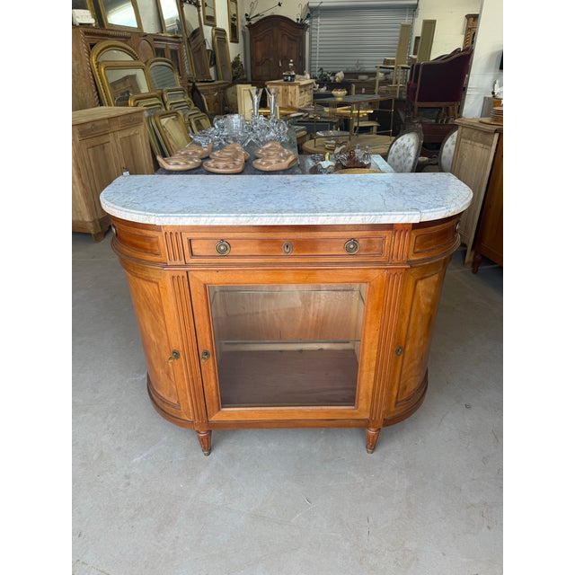 Fine 19th century French Louis XVI sideboard made of solid mahogany with a beveled Carrara marble top. The wood has been...