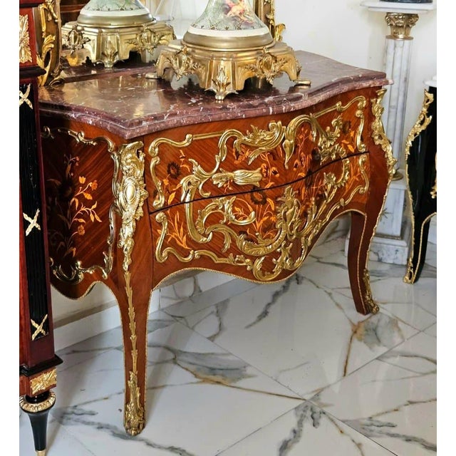 A true masterpiece of French-inspired luxury, this stunning Louis XV Bombe Commode showcases an elegant serpentine...