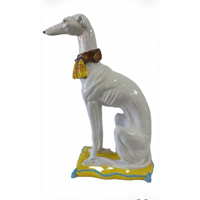 A mid century Hollywood Regency style ceramic greyhound statue. These lifelike terracotta figurines were often crafted in...