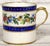 Soft Porcelain With a white background, the set features a polychrome decoration of floral garlands running between two...