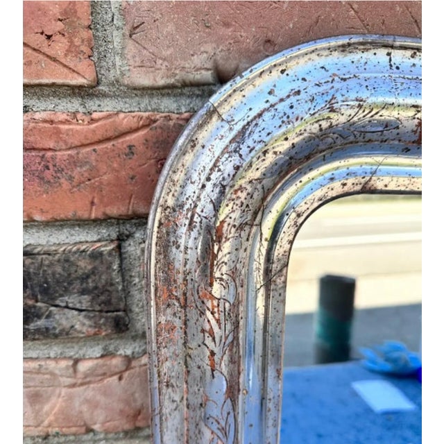 This 19th century Louis Philippe mirror is truly unique! Silver Louis Philippe style mirrors are not as common as gold,...