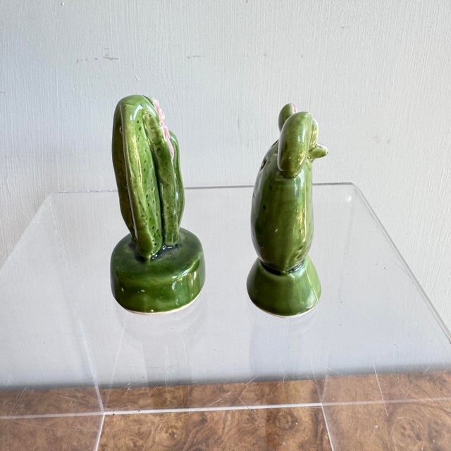 Circa 1950s Japanese-made ceramic salt and pepper shakers that favor petite cacti. Both are in good condition and both...