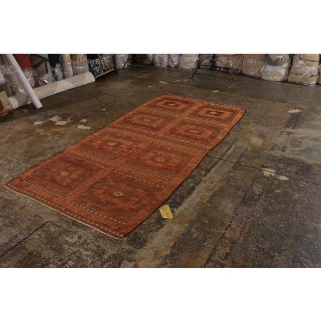 This vintage 4×9 Afghan Kilim is handwoven in wool and originates circa 1950-1960. It boasts an uncommon technique, and a...