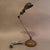 Industrial, desk lamp by Faries features an adjustable painted steel pea shade with articulating brass body and graduated...