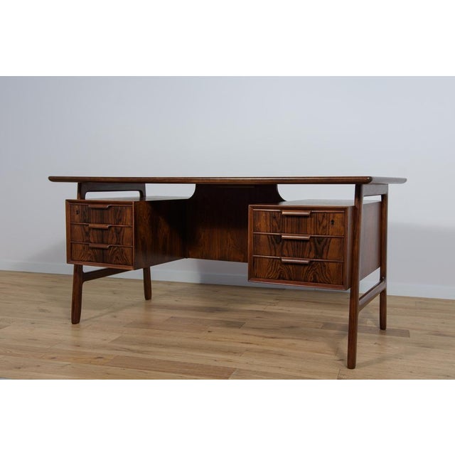 Mid-Century desk, model 75, produced by Omann Jun danish furniture factory. A desk with a high craftsmanship of design and...