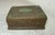 This antique 19th-century hand-tooled copper cigarette box from China features intricate carvings and inlays of green...
