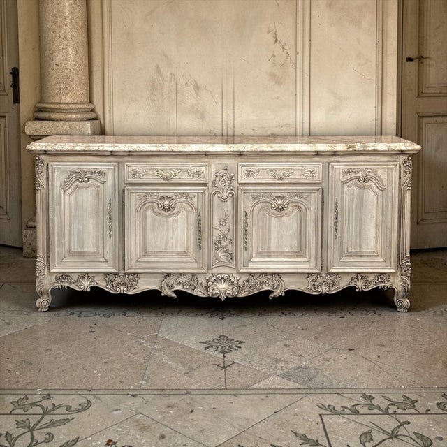 This impressive Antique Country French Buffet was executed in richly carved walnut then painstakingly stripped to reveal...
