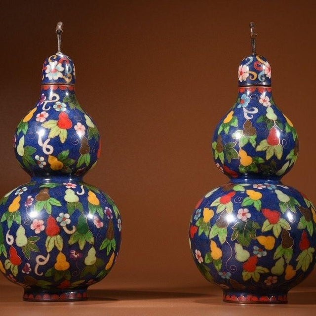 This is a charming pair of vintage Chinese cloisonné enamel double-gourd vases (huluping), crafted from copper. The...