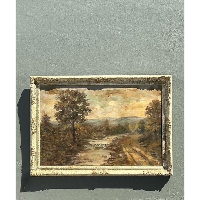 This large-scale vintage oil on canvas depicts a serene river winding through a lush, sun-drenched landscape. The artist...