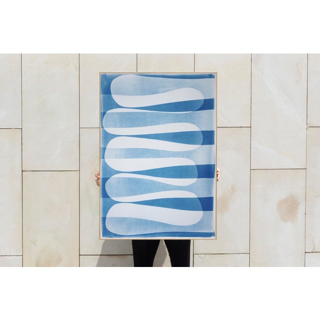 "Wavy Stripes" is a minimalist cyanotype monotype presents a quiet study of rhythm and balance through softly undulating...