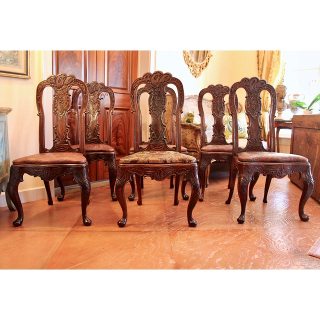 A remarkable set of antique Rococo carved walnut dining chairs, designed with bold curves and great details. Cabriole legs...