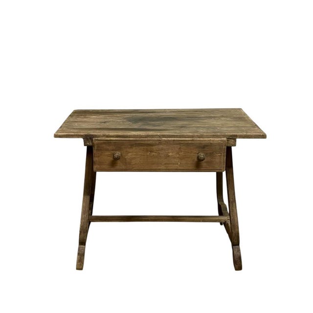 Catalan rustic table, circa 1850 (19th century), made of pine wood, with a central drawer featuring two knobs, a typical...