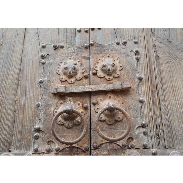 Antique Chinese Pine "Garden" Compound Gate, of monumental proportions featuring iron strapping with nailheads and a very...