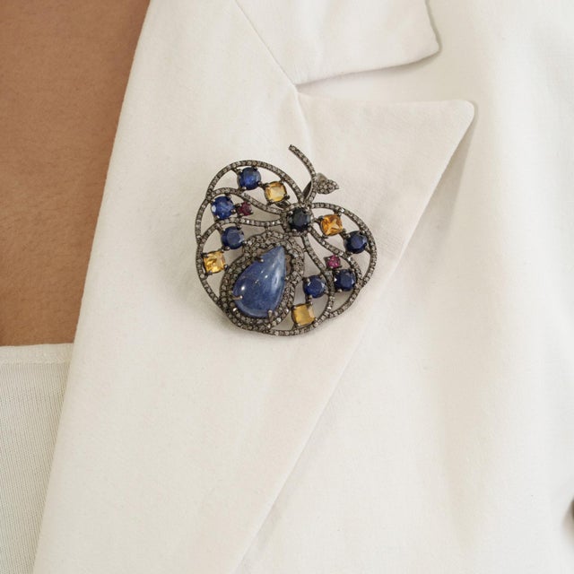 The whimsical Orchard Tanzanite, Ruby & Citrine Apple Brooch Pendant in 925 Sterling Silver brings playful charm to fine...