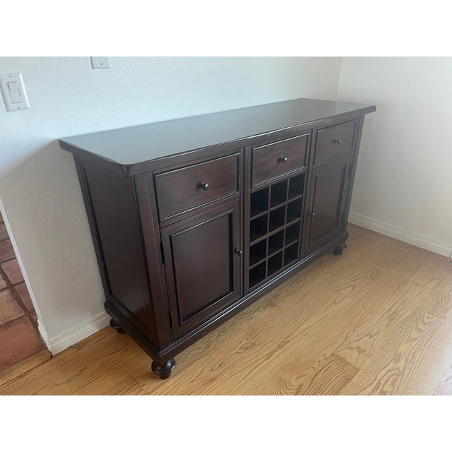This elegant Pottery Barn Montego buffet is a standout piece in any dining room, crafted from solid mahogany in a rich...