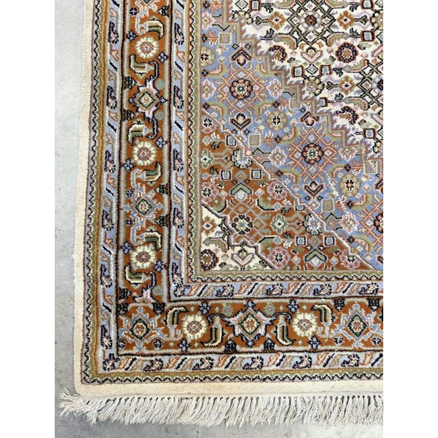 A striking hand-knotted Bijar rug distinguished by its bright, lively colours and finely detailed design. It features a...
