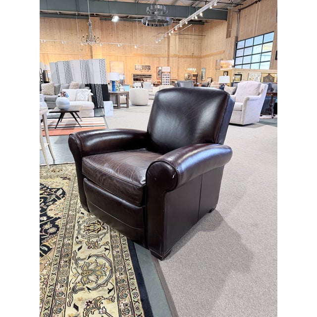 A beautifully proportioned Mitchell Gold club chair upholstered in rich brown leather, showcasing a naturally worn patina...