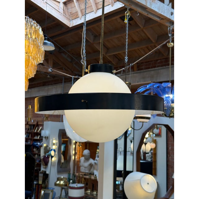An iconic "Disco Volante" pendant light by Stilnovo, Italy, dating from the 1960s. This celebrated design features a...