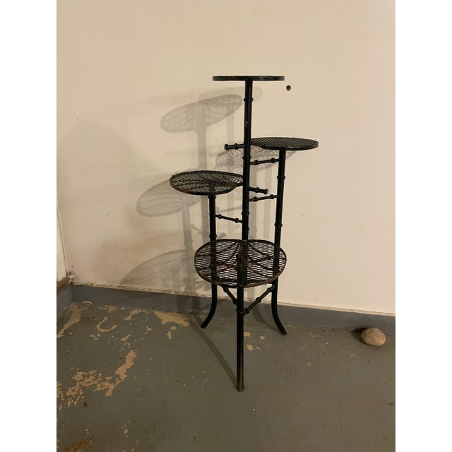 This fantastic iron plant stand is iron. There are 4 tears of faux lily pad leaves perched on faux bamboo columns. It’s...