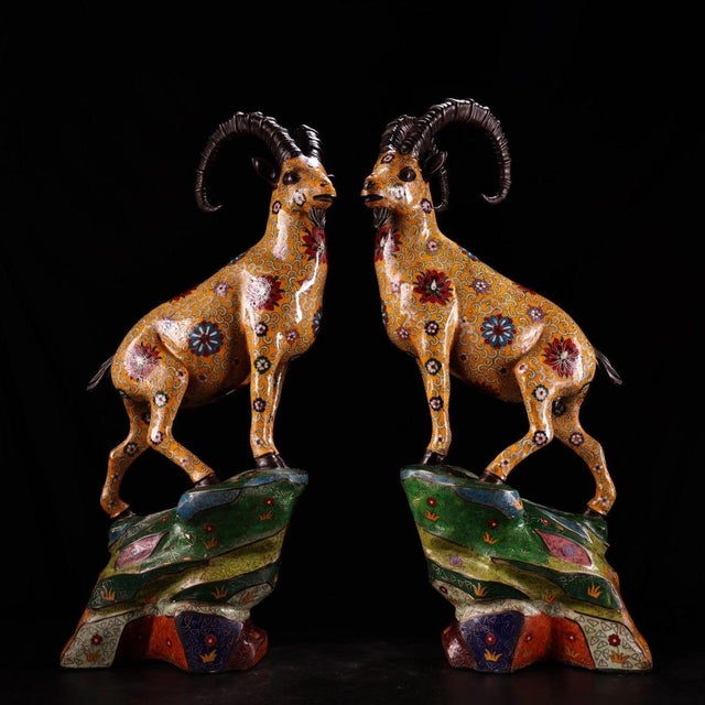 This striking pair of figures depicts recumbent ibex or rams, traditional symbols of leadership and resilience. Each...