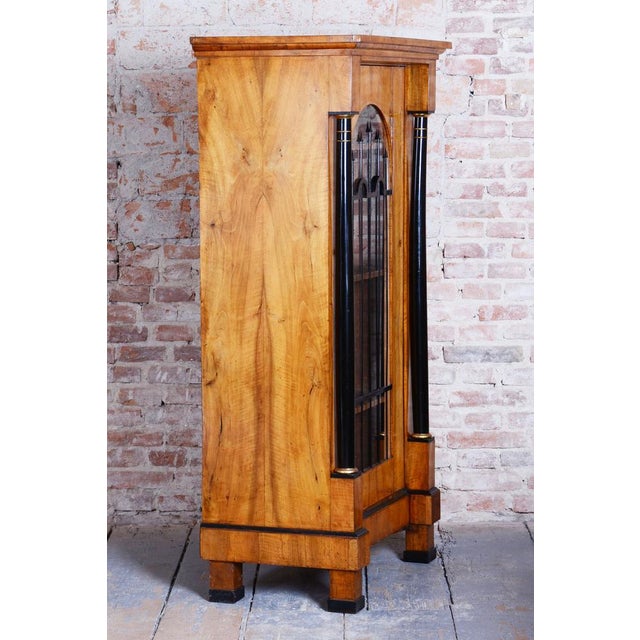 This stunning display cabinet, crafted in the Biedermeier style, dates back to the early 19th century and was made in...