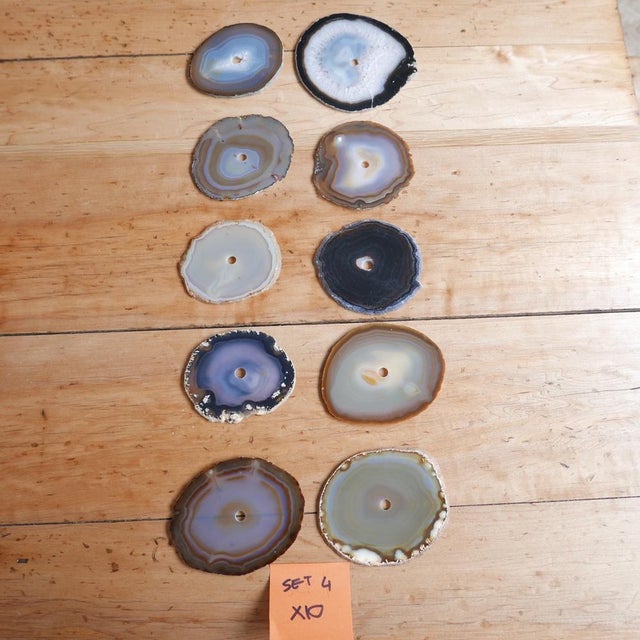 A set of natural stone circular drink place mats or coasters. Likely Agates. France, c1970s. A variety of colours and...