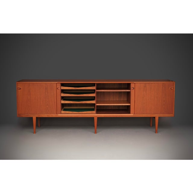 A very rare sideboard with sliding doors designed by one of the best of Danish designers for one of the top Danish...