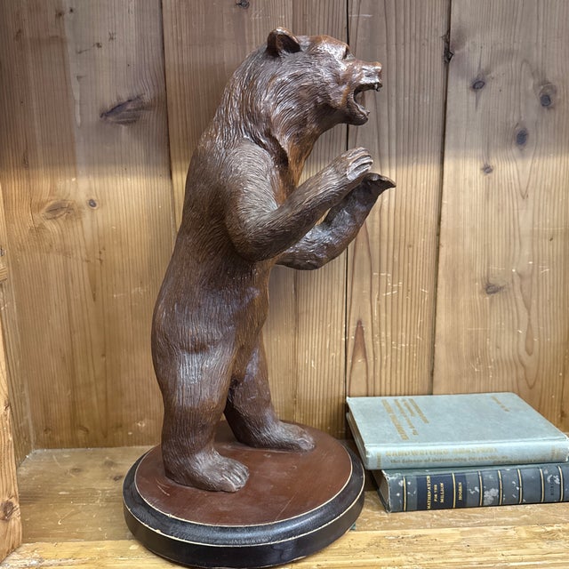 Heavy Black Forest standing bear. 20” x 14” x 14” He is a cast composite resin -I. Dark wood finish.