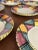 Superb set of 8 hand-painted ceramic dessert plates in a style attributed to Vallauris. Each plate features a colorful...