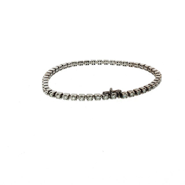A refined 21st-century 14k white gold tennis bracelet. This features 48 brilliant-cut natural white diamonds with a total...