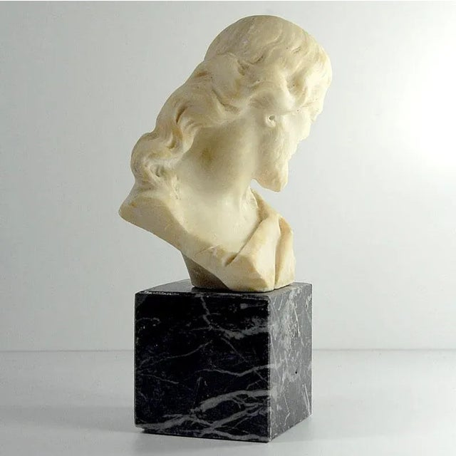 Bust of Christ, handcrafted from natural alabaster. Set on a polished black marble base. Dating from the turn of the 20th...