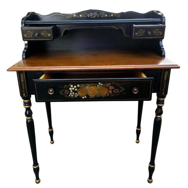 A stunning two-piece set featuring an Ethan Allen ebonized maple writing desk and matching rush-seat chair. This set is a...