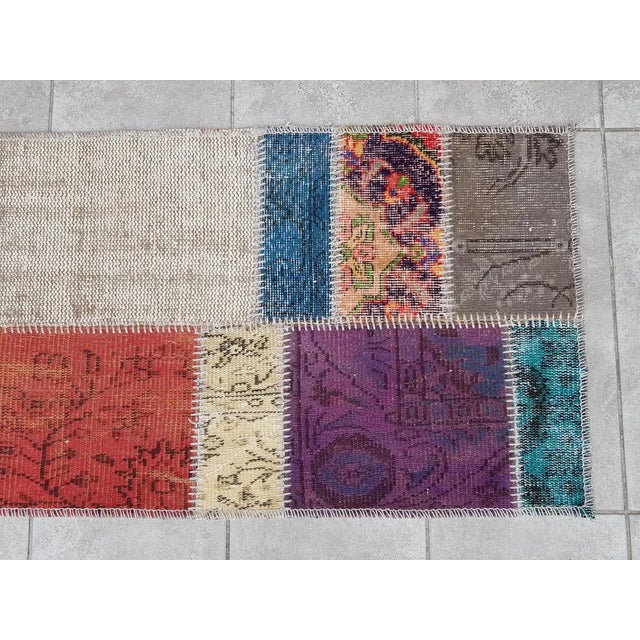 This is a vintage Turkish Oushak rug from the Mid 20th Century. The piece was hand-knotted.