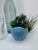 This small vase dates to the 1940's. Glazed in Van Briggle's turquoise Ming blue matte glaze. The moth/butterfly motif is...