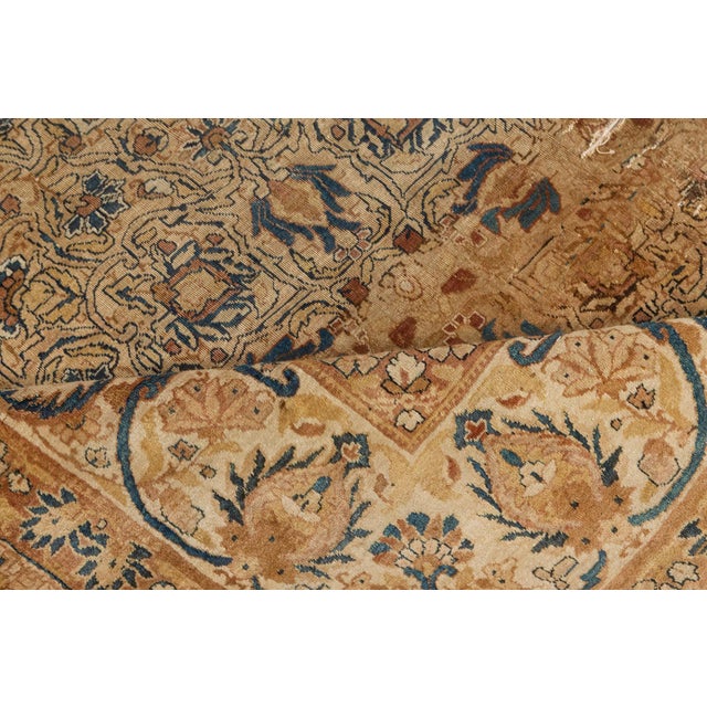 A finely-woven late 19th century Persian Kirman rug, the celadon field having a dense trellis design overall of miniature...