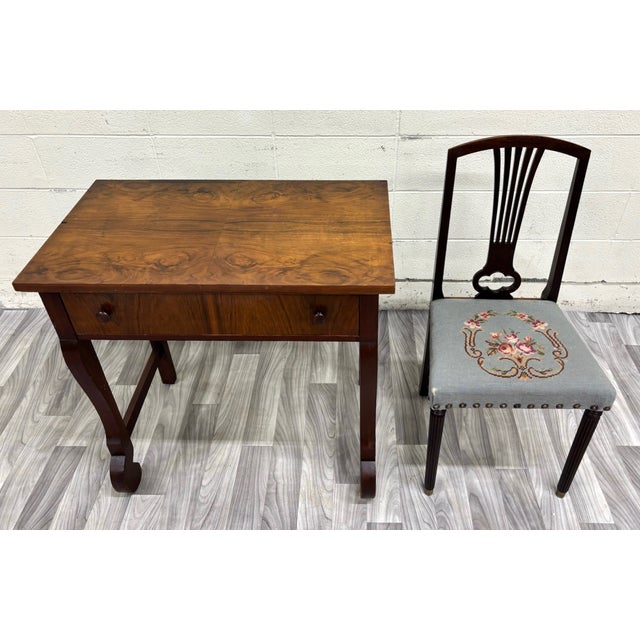 This is a beautiful antique American Empire mahogany writing desk accompanied by an elegant upholstered lyre-back chair,...