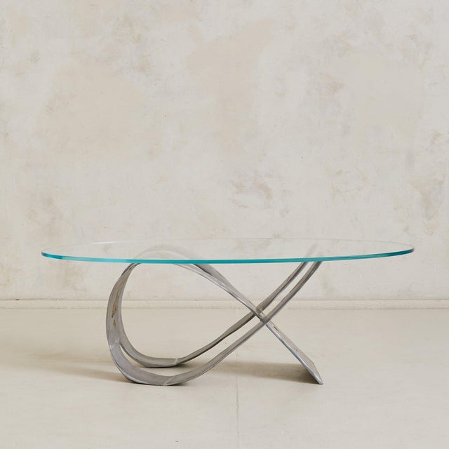 A sculptural Spanish coffee table from the 1980s, attributed to David Marshall. Cast in mixed metals, the sinuous base...