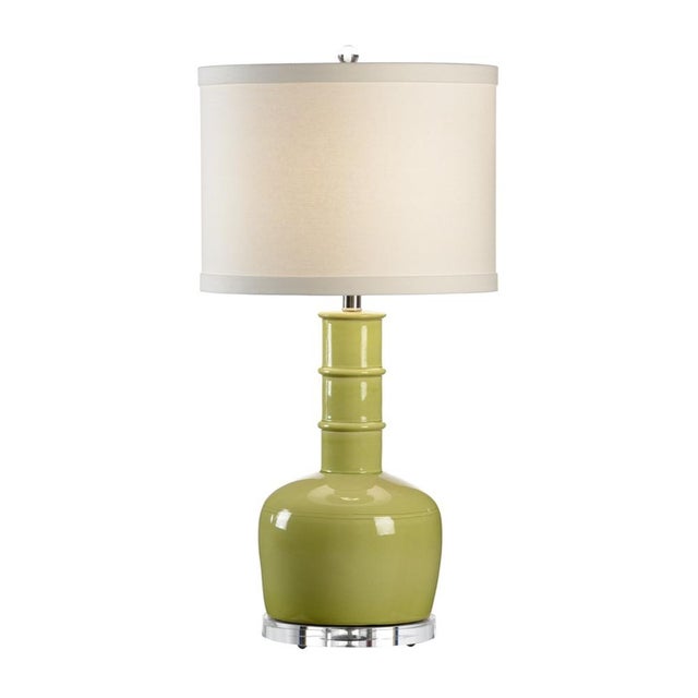 Enrich your decor by combining color and modern style with chang lamp. This 32" accent lamp features a kiwi green glazed...