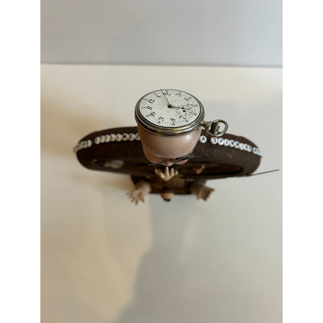 Thought provoking table top sculpture titled Finding Stillness in a Spinning World, created on an old pulley with...